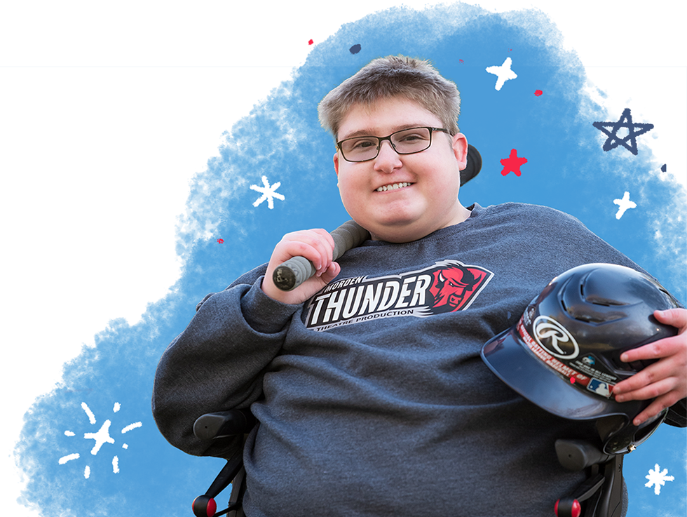 Evan smiling holding baseball bat and helmet